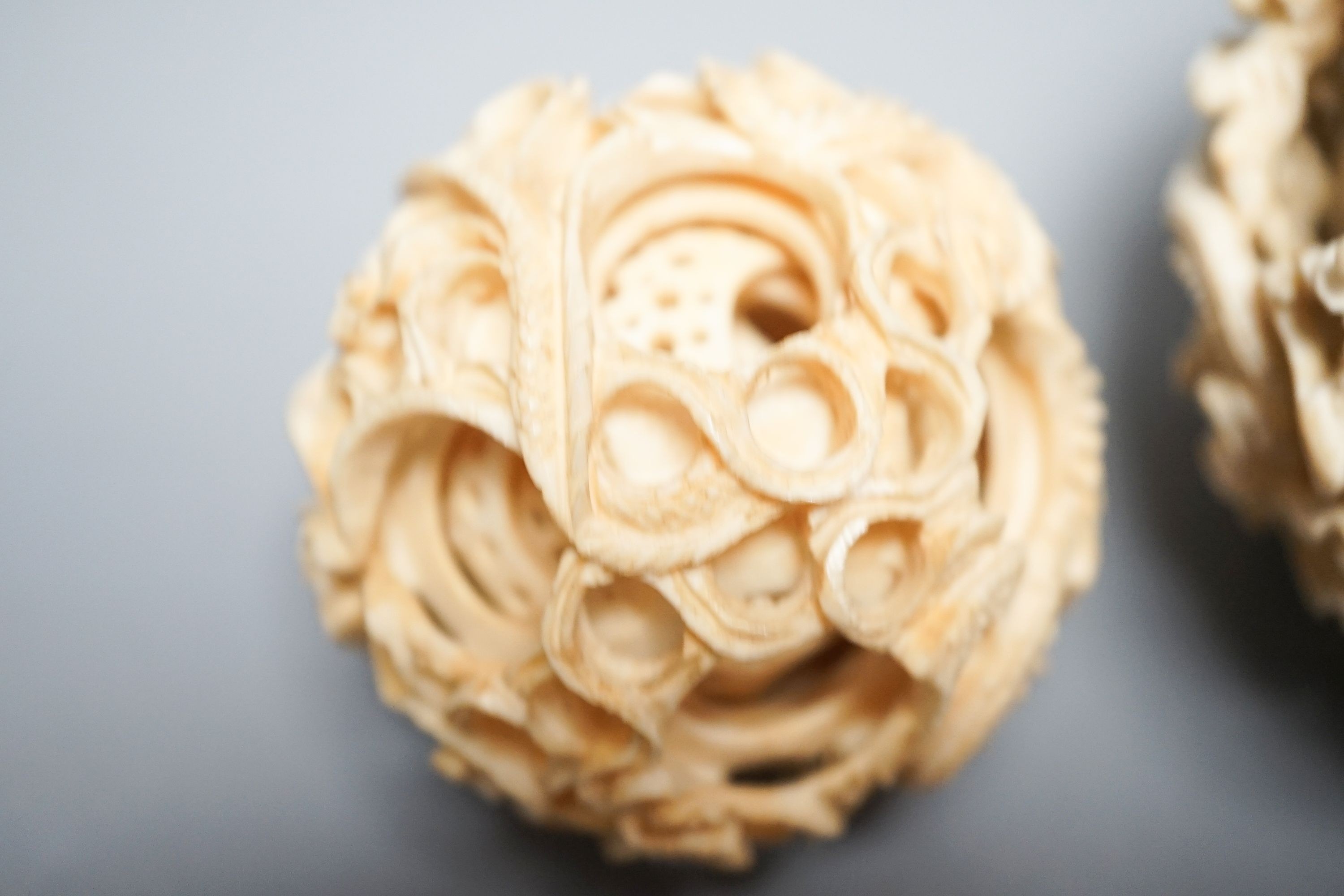 Two Chinese concentric ivory puzzle balls, first half 20th century, largest 8.6cm